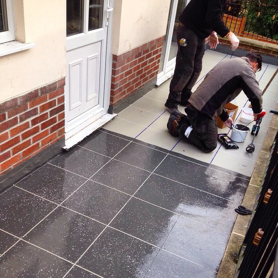 Protec team installing a tile-effect balcony finish