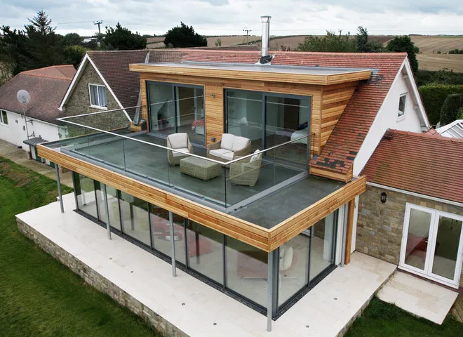 Contemporary home with a glass-balustraded roof terrace