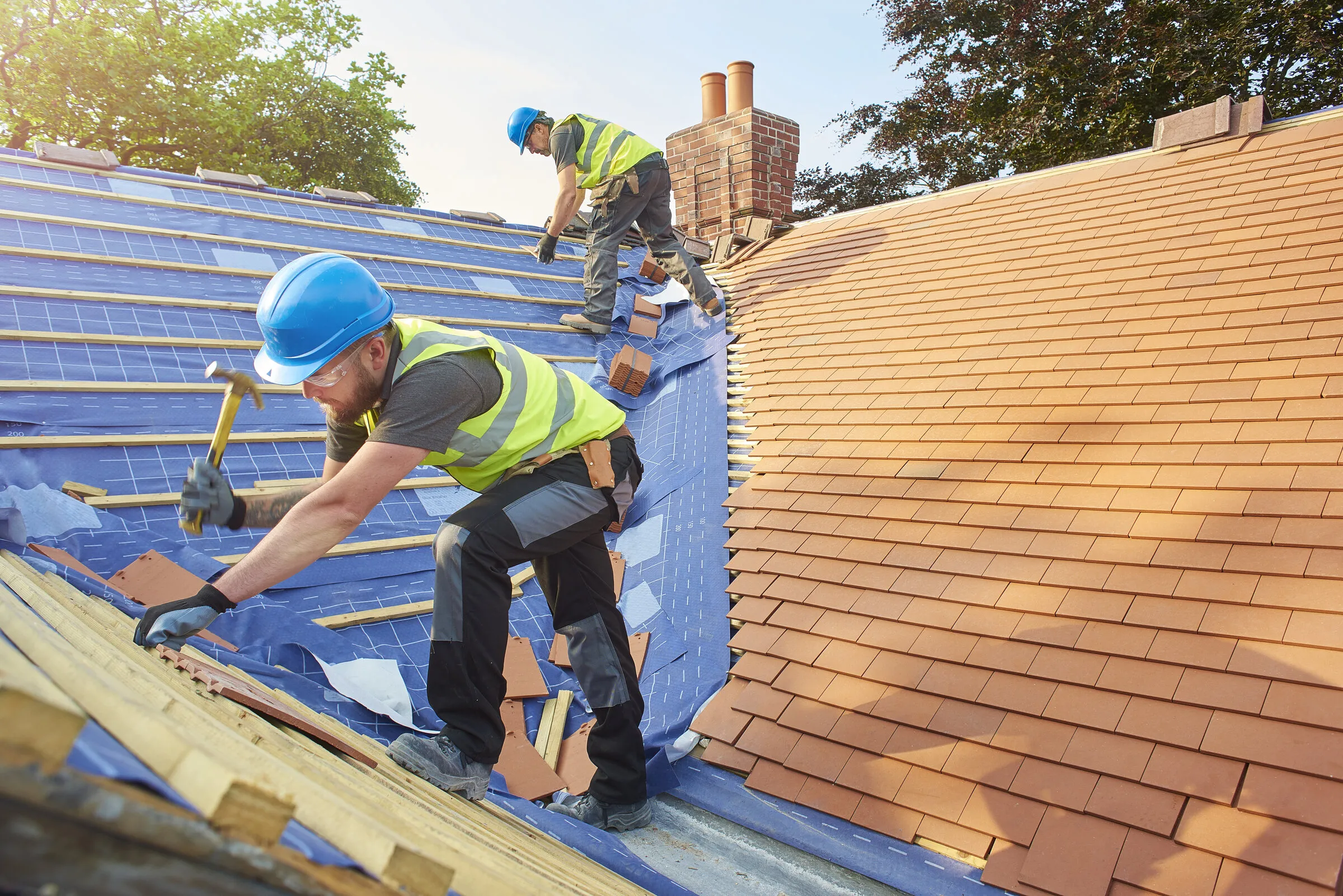 Protec roofers laying new clay tiles on a pitched roof