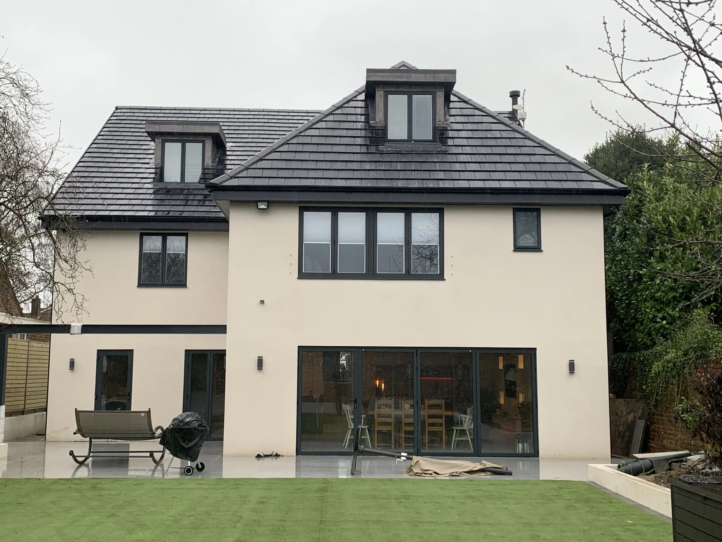 Detached house with a newly tiled pitched roof and dormer